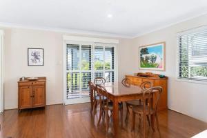 a dining room with a table and chairs at Bawley Beach Bungalow in Bawley Point