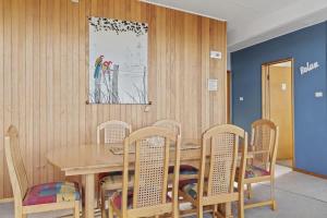 a dining room with a wooden table and chairs at SeaTreat in Mollymook +11 photos
