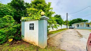 a box with a plant in it on the side of a road at Pedro's Hideaway, 1 Bedroom Home in Mangilao +1 photo