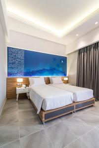 a bedroom with a large bed and a blue wall at Island Boutique Hotel in Rhodes Town