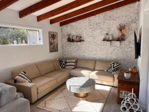 a living room with a couch and a table at Souira Beach House in Manyana