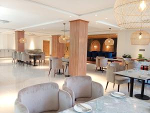 a dining room with tables and chairs in a room at IFQ Premier Skardu in Skardu