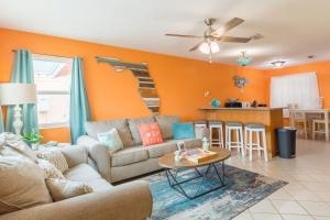 a living room with a couch and a table at Cowboy Pool Mini Golf Beach Ocean Center in Daytona Beach