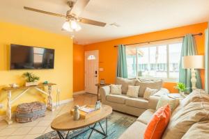 a living room with a couch and a table at Cowboy Pool Mini Golf Beach Ocean Center in Daytona Beach +41 photos