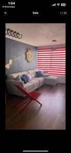 a living room with a couch and a table at Excelente departamento in Mexico City