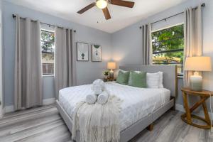 a bedroom with a bed with a teddy bear on it at 3br Hot Tub Retreat Steps From Bayshore Path! in Tampa