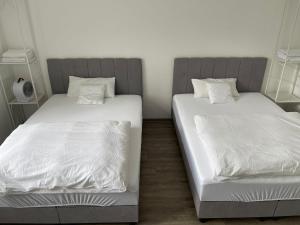 two beds sitting next to each other in a room at 2-4 People in Peaceful Room Kassel city in Kassel
