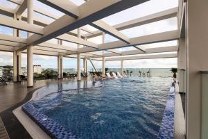 a swimming pool with a view of the water at Daystar Hotel in Phú Quốc