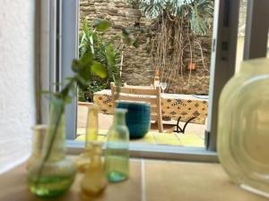a window with a bunch of vases on a table at Port-Vendres: Appartement T2 avec terrasse proche port - FR-1-309-537 in Port-Vendres +2 photos