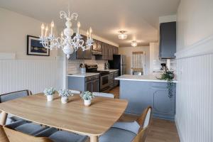 a kitchen and dining room with a table and chairs at Waterview, Bright Home Close To Town, Moran Park in Eastsound