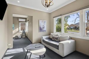 a living room with a couch and a window at Evies Cottage i Belmont Suites I regionalXscapes in Belmont
