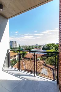 a balcony with a view of a city at Comfortable Villa Morra Loft in Asuncion