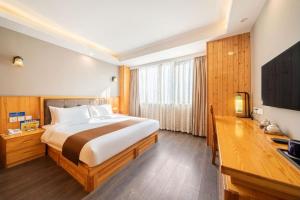 a bedroom with a large bed and a television at Huayi Hotel in Shanghai +33 photos