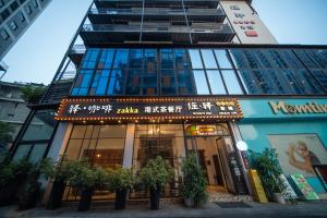 a building with a sign on the front of it at Zhangjiajie Wangyi Inn in Zhangjiajie