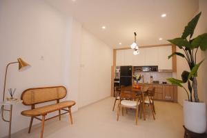 a kitchen and dining room with a table and chairs at GOtoBED in Mutiara Airport