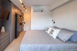 a small bedroom with a bed with pillows on it at BSide Faria Lima Pinheiros in Sao Paulo +17 photos