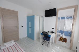 a bedroom with a desk and a chair in a room at Ciro BED AND BREAKFAST la villetta in Pioltello