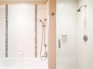 a bathroom with a shower with a glass door at The Powder Den Cozy Alpine Basecamp in Snowmass Village +18 photos
