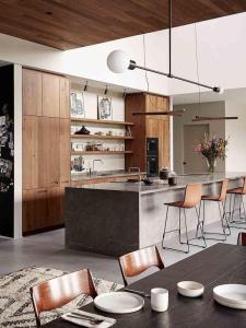 a kitchen with a table and chairs and a counter at The Cambridge in Warrane