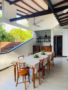 a dining room with a table and chairs at Heaven Of Hikka in Hikkaduwa +13 photos
