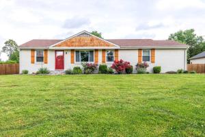 a house with a green lawn in front of it at Oasis Of Nashville, With A Pool And Hot Tub ! in Nashville