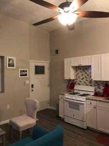 a kitchen with white cabinets and a stove top oven at North Valley Studio - Near Balloon Fiesta Park in Albuquerque