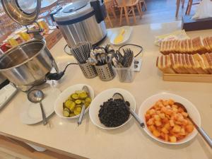 a counter with three bowls of fruits and vegetables on it at H avenue Kijang Ilgwang in Busan