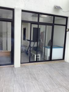 a room with large glass windows and a tv at Amp rental unit in Manila