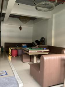 a living room with a ping pong table and couches at Amp rental unit in Manila