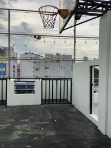 an empty basketball court with a hoop on a fence at Amp rental unit in Manila