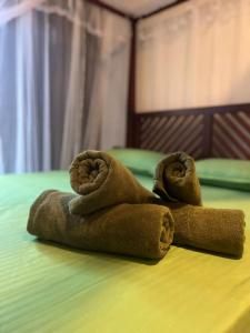 a couple of towels sitting on top of a bed at HERITAGE GREEN Ambalangoda in Ambalangoda +11 photos