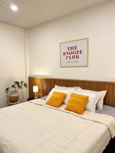 a bedroom with a bed with two yellow pillows at Yellow Stay in Āīzawl