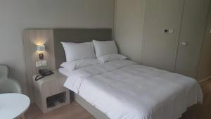 Postel nebo postele na pokoji v ubytování Hanting Hotel Beijing Beiqing Road Yongfeng Technology Park