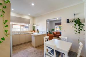 a kitchen and dining room with a white table and chairs at Bayside Bliss Family Friendly, Beach & Jetty in Busselton