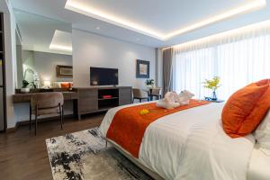 a bedroom with a bed with two stuffed animals on it at Sunshine Prestige Resort and Spa in Cha Am