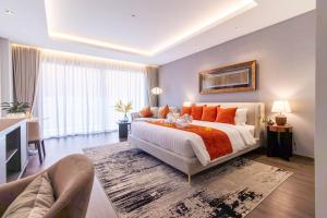 a bedroom with a large bed with orange pillows at Sunshine Prestige Resort and Spa in Cha Am +45 photos