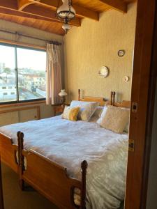a bedroom with a large bed with a large window at CasaOcho2 in Viña del Mar