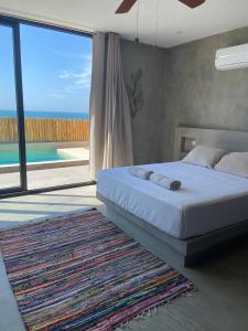 a bedroom with a bed and a view of a pool at La Morada - Casa de playa frente al mar en Estreno in Canoas De Punta Sal +31 photos