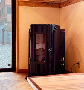 a black refrigerator in the corner of a room at Moyai House in Hakuba