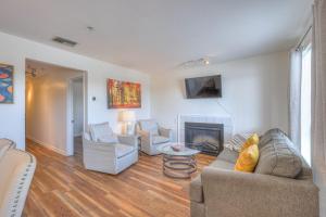 a living room with a couch and a fireplace at Riverfront Retreat-Near Broadway, Pool, Park Free in Nashville