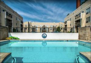 a swimming pool in front of a building at Riverfront Retreat-Near Broadway, Pool, Park Free in Nashville