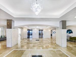 a lobby of a building with a chandelier at Luxury Beachfront Condo By Pmi in Fort Lauderdale +61 photos