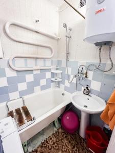 a bathroom with a bath tub and a sink at Cozy Seaside Apartment in Lahemaa in Loksa +16 photos