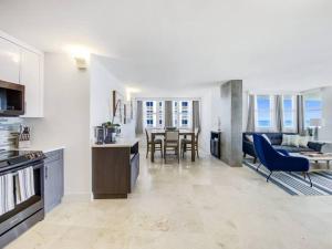 a kitchen and living room with a table and chairs at Luxury Beachfront Condo By Pmi in Fort Lauderdale