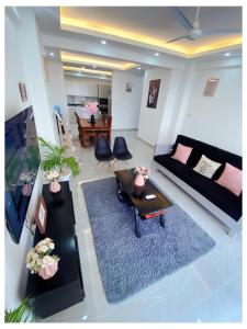 a living room with a couch and a table at Sakura Aqua Gardens in Mombasa