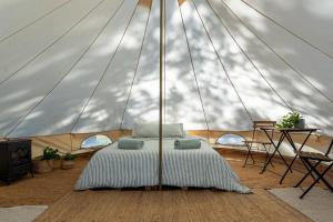 a bed in a marquee in a tent at Glamping by the beach in Hanko