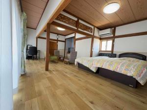 a bedroom with a bed and a wooden floor at TC1 Nagano - Vacation STAY 10022v in Okaya +57 photos