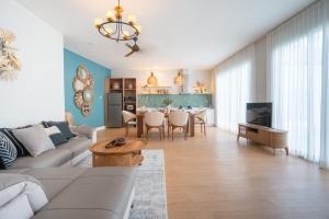 a living room with a couch and a table at Villa Palma Blanca Canggu by Nagisa Bali in Canggu