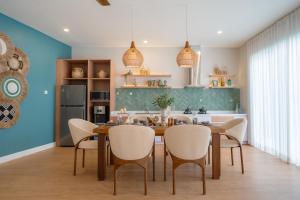 a dining room with a table and chairs at Villa Palma Blanca Canggu by Nagisa Bali in Canggu