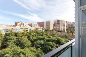 a balcony with a view of trees and buildings at New Apartment With Private Rooftop in Hospitalet de Llobregat